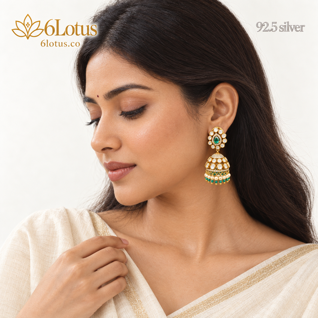 1002 green jhumka earrings worn with an ivory saree